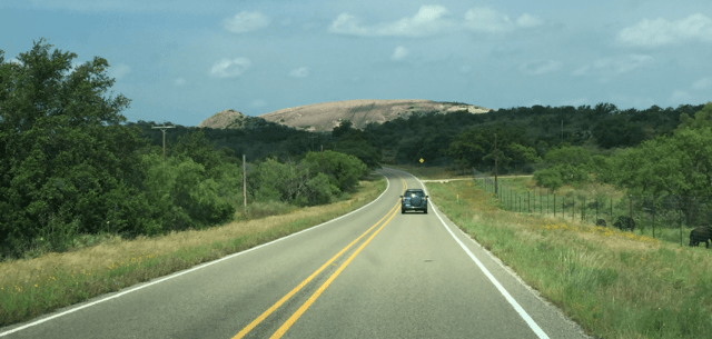 A view of Enchanted Rock as you approach in a car /  Wikimedia Commons / HAL333 

Link: https://commons.wikimedia.org/wiki/File:Enchanted_Rock_View.png