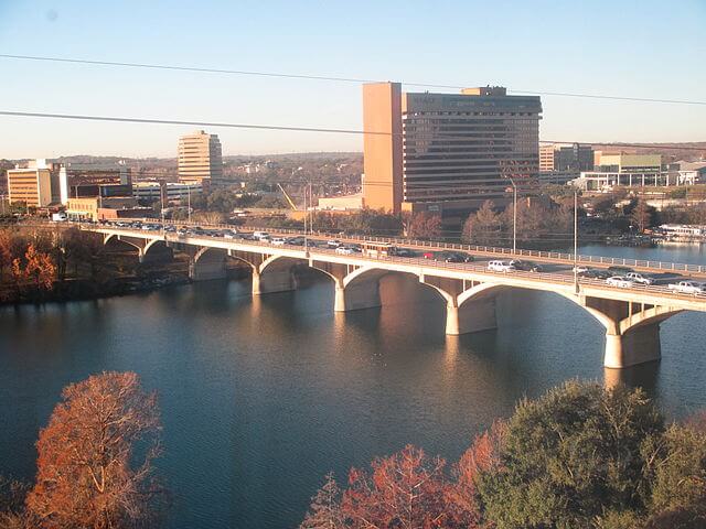 An Aerial View of the Ann W. Richards Congress Avenue Bridge / Wikimedia Commons / Billy Hathorn (assumed).

Link: https://commons.wikimedia.org/wiki/File:Congress_Ave._Bridge_atop_Lake_Lady_Bird,_Austin,_TX_IMG_6286.JPG