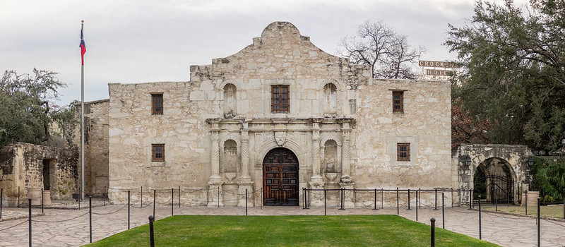 An exterior view of The Alamo / Flickr / Jonathan Cutrer
Link: 
https://www.flickr.com/photos/joncutrer/47353601221/in/photolist-2f9tzSn-9ALpe-rLsDa-2iwSj6S-2fAYQkY-8sjCrV-8sjCqa-26YzNSg-6PrVom-9Njohw-q2eLwF-i82YZf-6JfBTk-72Mjd-9r1txj-4gdqbV-4EyMK3-4K22rL-RcRKRj-4ZYCyf-eVH1Kh-9XSc3Y-2mHJdzm-2isgW48-jvjZCe-51BYR7-GCxPuG-kaGmUy-5ej2Xe-2ohoDyn-2o8kBne-2fUforP-U1Wi97-bsPUgw-oQPiLt-2iLvfrf-7D6EuT-edY6Sh-JSXuU2-2wAb-FwTk1B-4x3PHf-dUFkLU-7eeuRt-6Z8PYY-QpakwZ-2mjsauR-edrYpB-2kUocHr-2hSLoNT